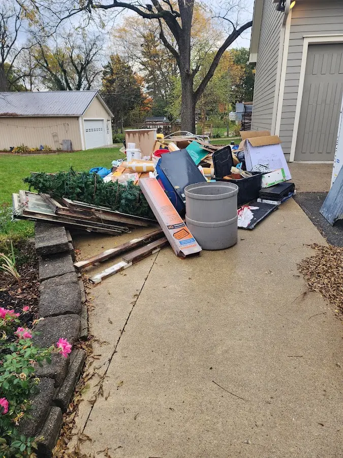 Dumpster being loaded with debris for Estate Cleanout Dumpster Rental in Sully Square
